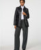 Long lamb leather shirt jacket with patch pockets and button front, blending utility with polish.