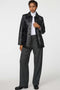 Long lamb leather shirt jacket with patch pockets and button front, blending utility with polish.