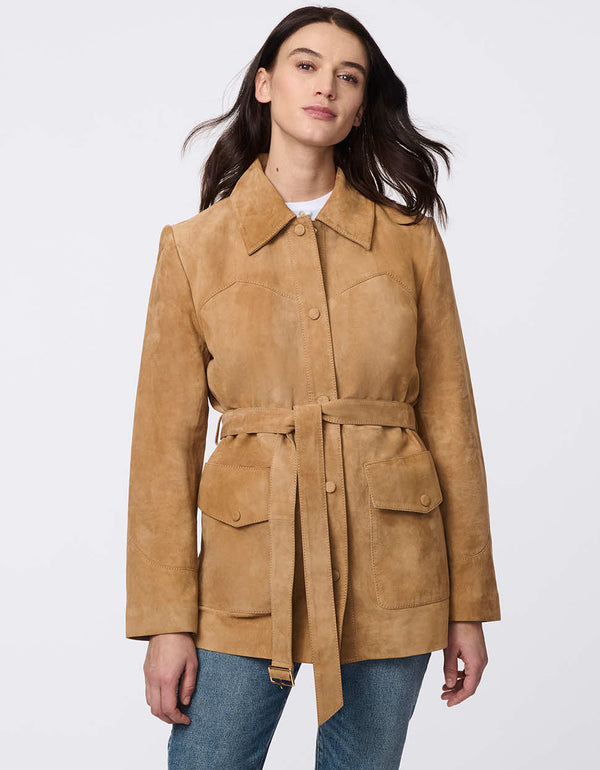 Luxe goat suede jacket with curved yoke stitching, flap pockets, belted waist, and polished snap closures. Modern Western-inspired elegance with tailored details.