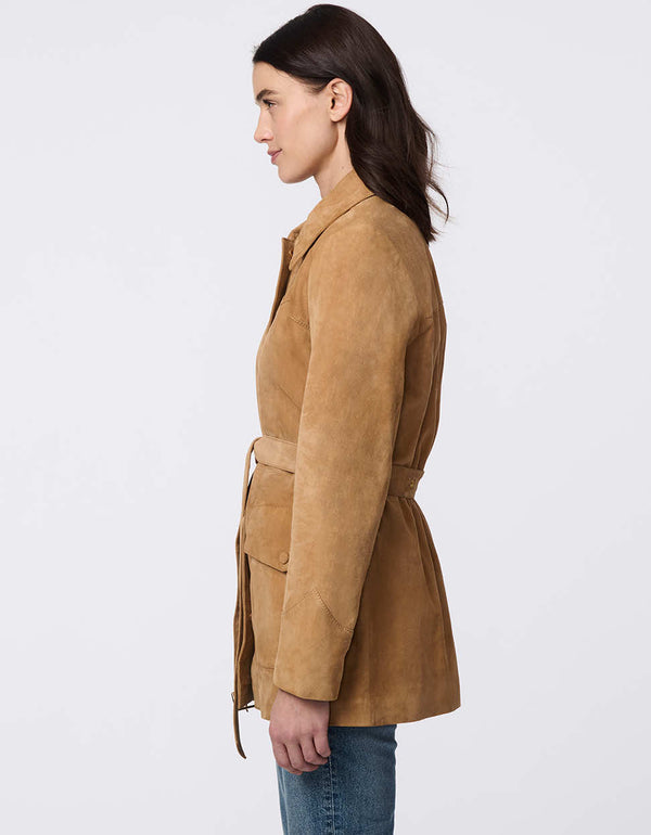 Luxe goat suede jacket with curved yoke stitching, flap pockets, belted waist, and polished snap closures. Modern Western-inspired elegance with tailored details.