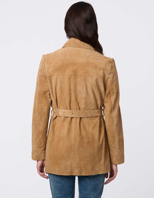 Luxe goat suede jacket with curved yoke stitching, flap pockets, belted waist, and polished snap closures. Modern Western-inspired elegance with tailored details.