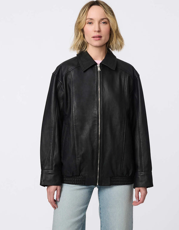 Minimalist leather jacket with sleek zip closure, elastic bottom hem, and streamlined silhouette. Effortlessly cool and versatile for day-to-night looks.