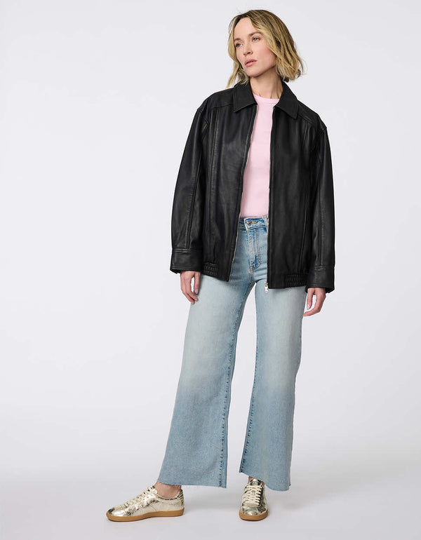 Minimalist leather jacket with sleek zip closure, elastic bottom hem, and streamlined silhouette. Effortlessly cool and versatile for day-to-night looks.