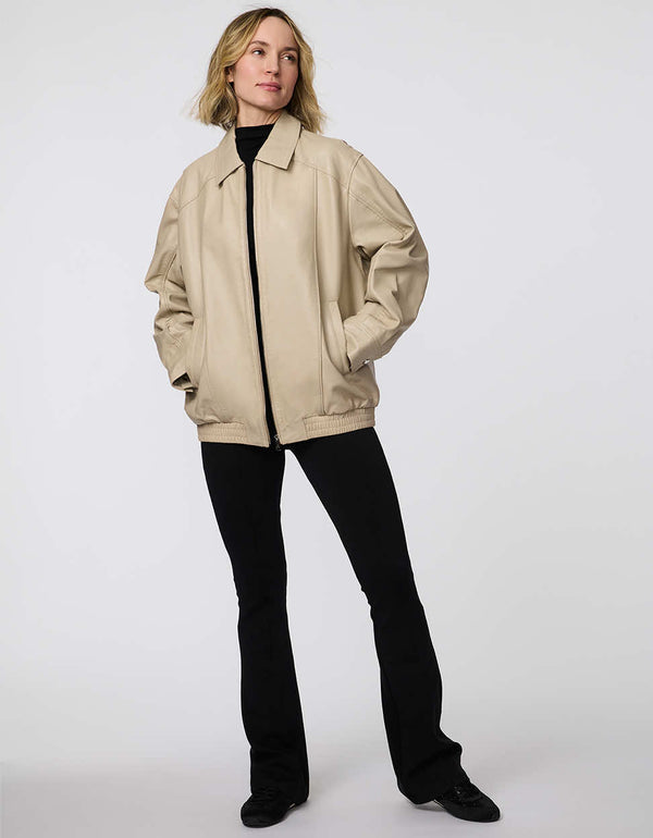 Minimalist leather jacket with sleek zip closure, elastic bottom hem, and streamlined silhouette. Effortlessly cool and versatile for day-to-night looks.