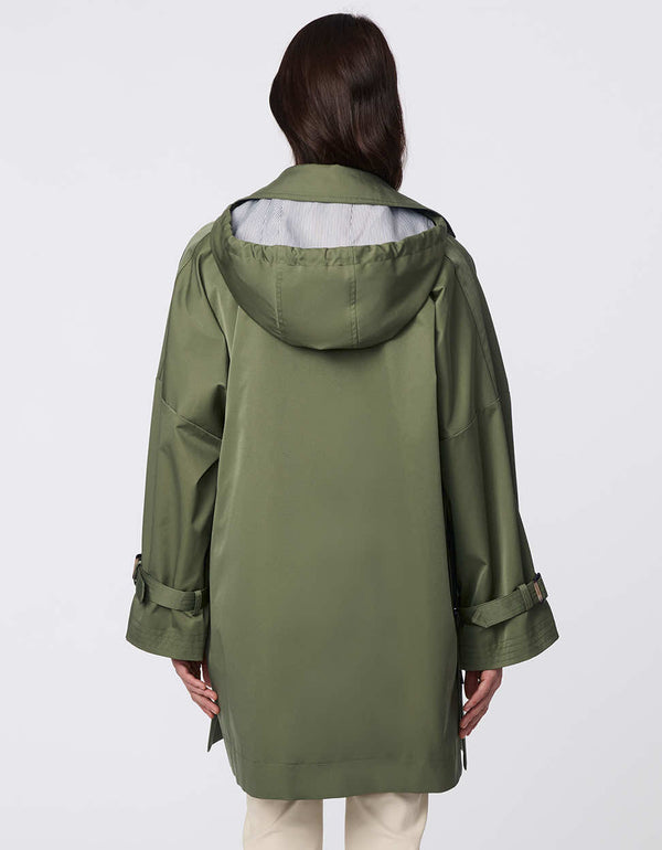 Oversized double-breasted trench with adjustable cuff straps, drawstring hood, and side button accents. Effortless, sophisticated layering piece.