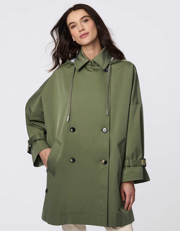 Oversized double-breasted trench with adjustable cuff straps, drawstring hood, and side button accents. Effortless, sophisticated layering piece.