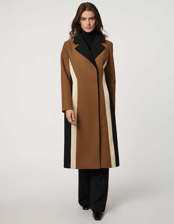 A women walking in a tailored wool color block coat.