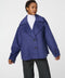 Double-breasted cropped wool jacket with oversized notch collar and cuffed sleeves for tailored layering.