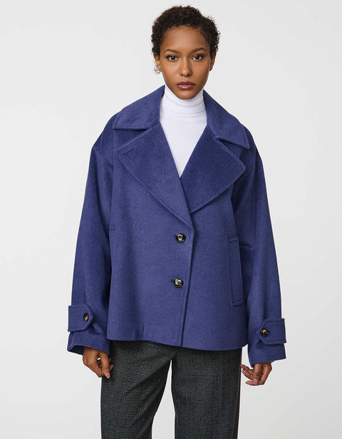 Double-breasted cropped wool jacket with oversized notch collar and cuffed sleeves for tailored layering.