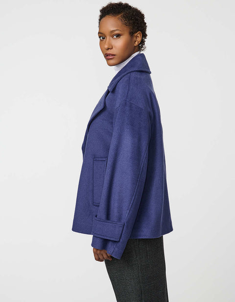 Double-breasted cropped wool jacket with oversized notch collar and cuffed sleeves for tailored layering.