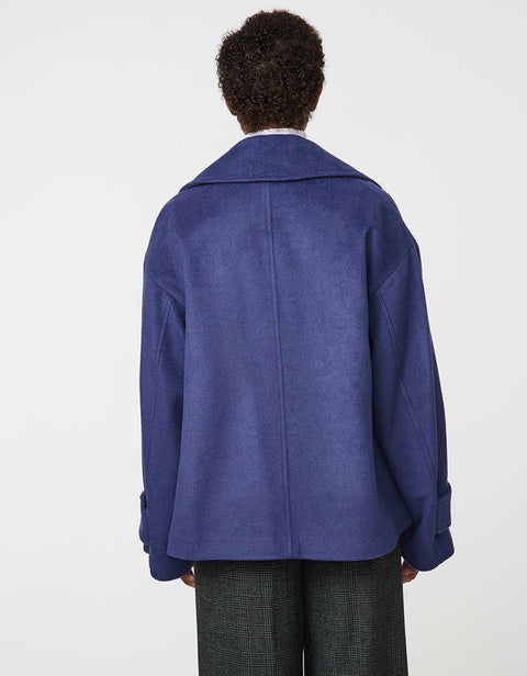 Double-breasted cropped wool jacket with oversized notch collar and cuffed sleeves for tailored layering.