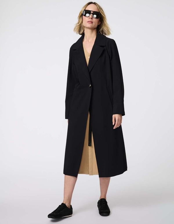 Women's Voyager Stretch Duster, a long, travel-ready jacket with a single-button closure and deep pockets for on-the-go versatility.