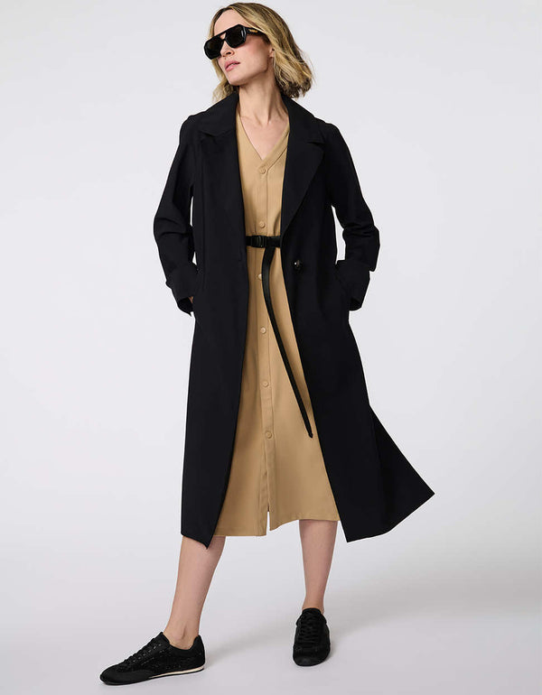 Women's Voyager Stretch Duster, a long, travel-ready jacket with a single-button closure and deep pockets for on-the-go versatility.