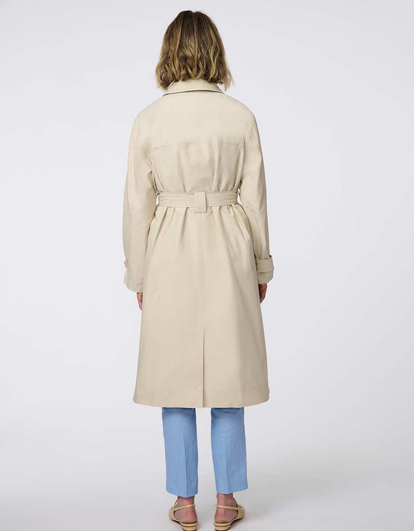 Modern trench coat with belted silhouette, contrast button details, removable quilted vest liner, and storm flap accents for versatile, seasonal styling