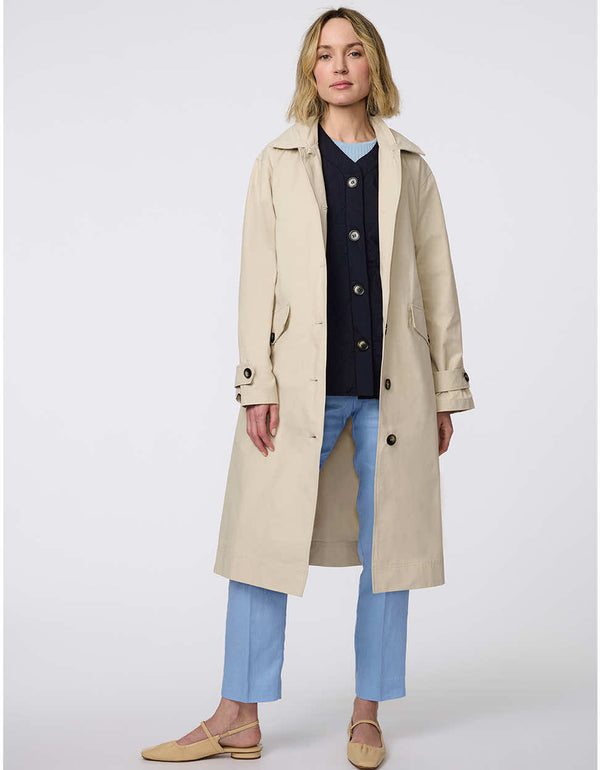 Modern trench coat with belted silhouette, contrast button details, removable quilted vest liner, and storm flap accents for versatile, seasonal styling