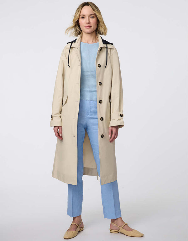 Modern trench coat with belted silhouette, contrast button details, removable quilted vest liner, and storm flap accents for versatile, seasonal styling