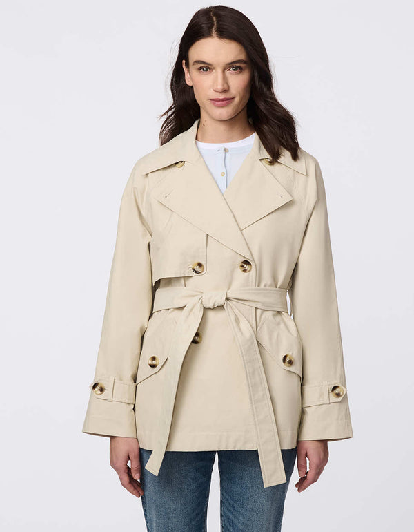 Women's cropped trench coat in a bone color, featuring a double-breasted front and  belted waist. A modern take on the timeless trench, perfect for layering in transitional weather.