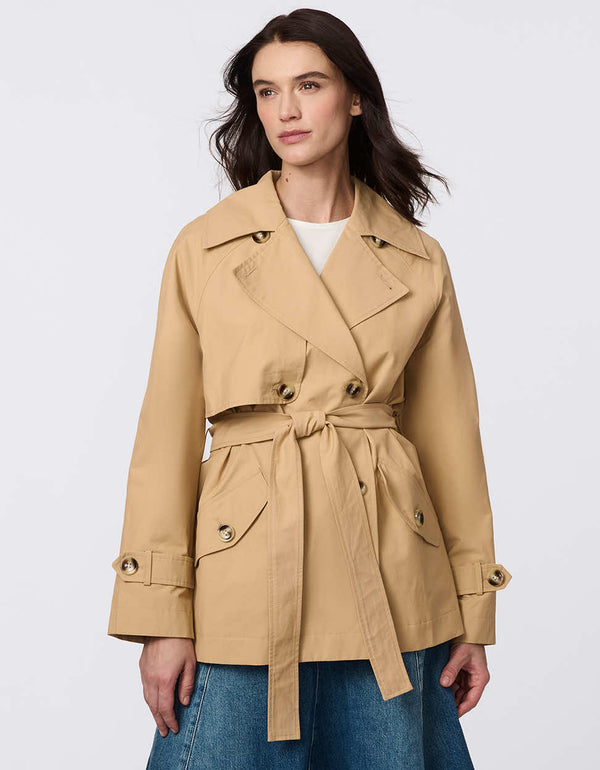 Women's cropped trench coat in a bone color, featuring a double-breasted front and  belted waist. A modern take on the timeless trench, perfect for layering in transitional weather.