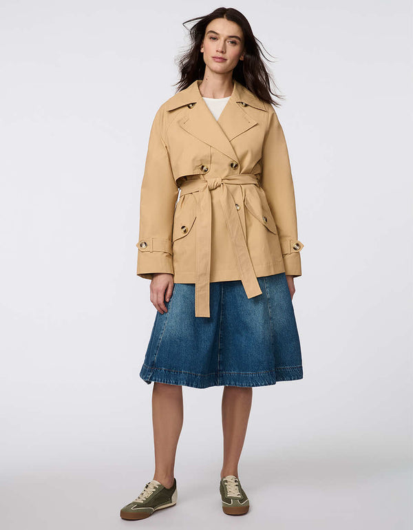 Women's cropped trench coat in a bone color, featuring a double-breasted front and  belted waist. A modern take on the timeless trench, perfect for layering in transitional weather.