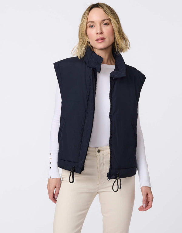 Lightweight puffer vest with adjustable hem and floral interior lining. Stylish, versatile layering piece perfect for on-the-go comfort.