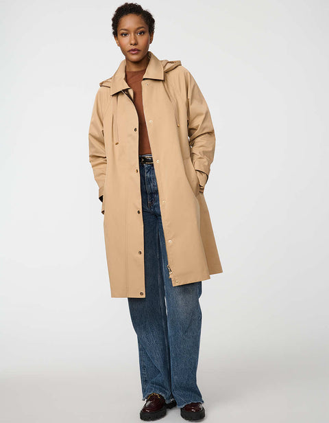 Oversized water-repellent trench coat with snap-off hood and button-flap zip closure, ideal for transitional layering.