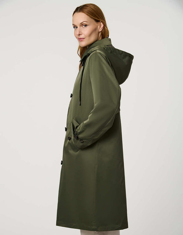 Women’s raincoat with hood, cinched waist, flap pockets, and zip-off hood in a tailored, versatile design.