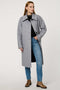 Women’s plaid wool coat with oversized calf-length fit, dramatic collar, and two-button single-breasted front.