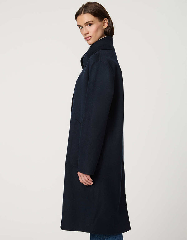 Women’s plaid wool coat with oversized calf-length fit, dramatic collar, and two-button single-breasted front.