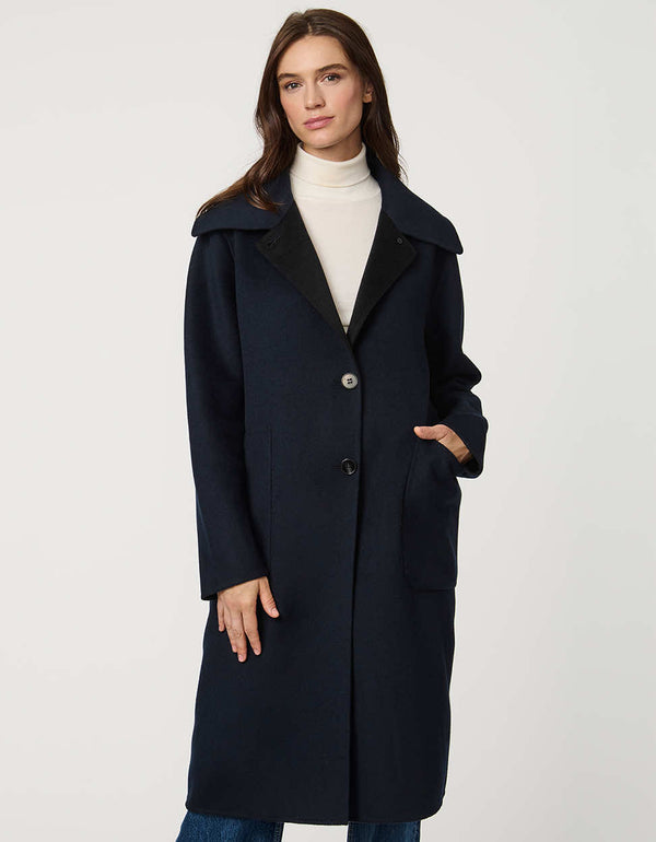Women’s plaid wool coat with oversized calf-length fit, dramatic collar, and two-button single-breasted front.
