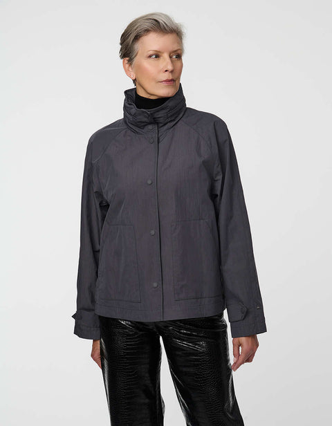 Waist-length water-repellent jacket with roll-away hood and patch pockets, designed for everyday layering.