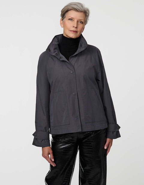 Waist-length water-repellent jacket with roll-away hood and patch pockets, designed for everyday layering.