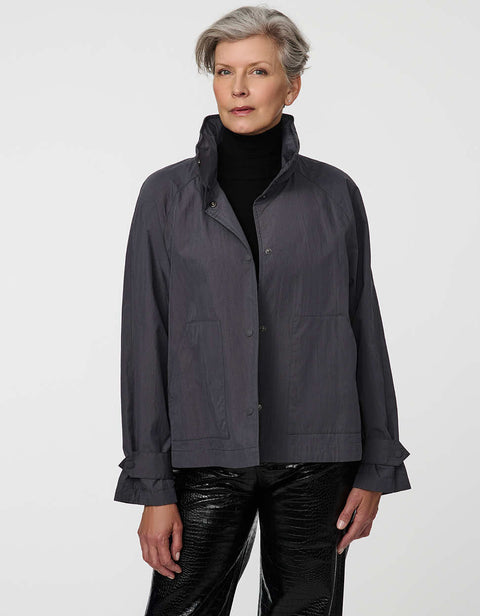 Waist-length water-repellent jacket with roll-away hood and patch pockets, designed for everyday layering.