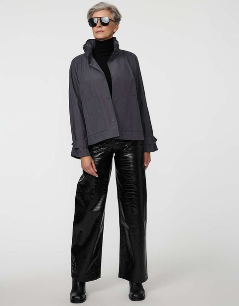 Waist-length water-repellent jacket with roll-away hood and patch pockets, designed for everyday layering.