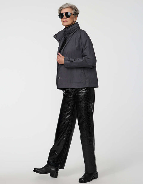 Waist-length water-repellent jacket with roll-away hood and patch pockets, designed for everyday layering.