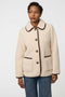 Plush sherpa coat with contrast trim, tortoise shell buttons, and patch pockets for cozy styling.