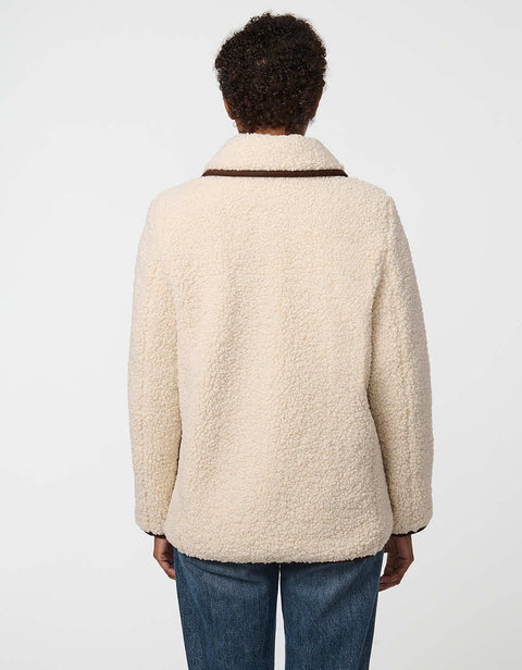 Plush sherpa coat with contrast trim, tortoise shell buttons, and patch pockets for cozy styling.