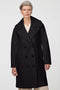 Calf-length double-breasted wool coat with oversized lapels, offering timeless sophistication and warmth.