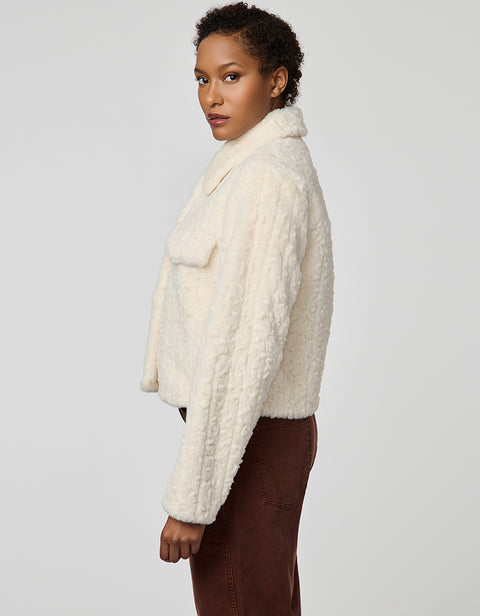 Cropped groove-textured faux fur jacket with button front and flap chest pockets for stylish layering.