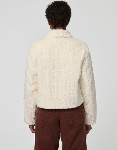 Cropped groove-textured faux fur jacket with button front and flap chest pockets for stylish layering.