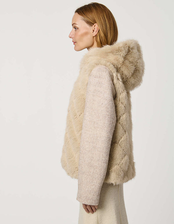 Hip-length faux fur coat with jacquard diamond pattern, wool sleeves, cozy hood, and zip closure for modern style.