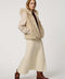 Hip-length faux fur coat with jacquard diamond pattern, wool sleeves, cozy hood, and zip closure for modern style.