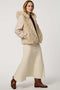Hip-length faux fur coat with jacquard diamond pattern, wool sleeves, cozy hood, and zip closure for modern style.