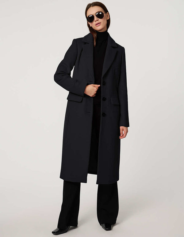 Women’s knee-length wool coat with tailored darts, patch pockets, and single-breasted three-button front.