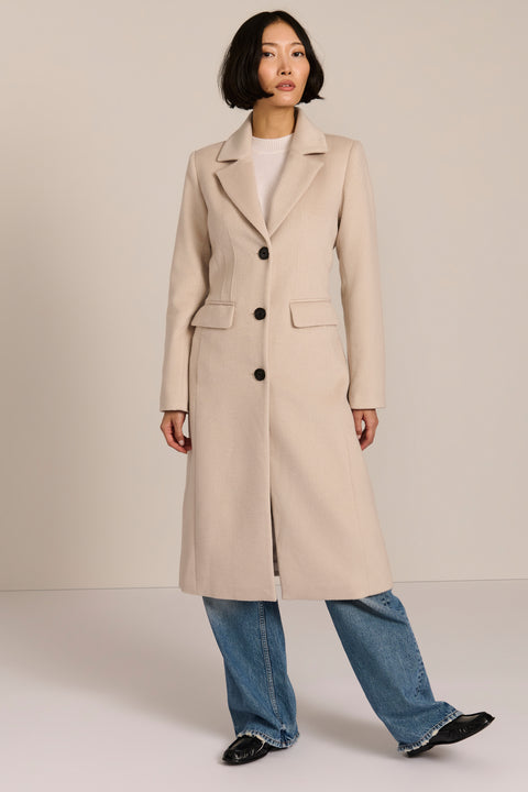 Women’s knee-length wool coat with tailored darts, patch pockets, and single-breasted three-button front.
