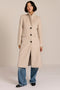 Women’s knee-length wool coat with tailored darts, patch pockets, and single-breasted three-button front.