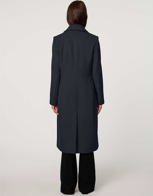 Women’s knee-length wool coat with tailored darts, patch pockets, and single-breasted three-button front.