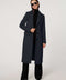Women’s knee-length wool coat with tailored darts, patch pockets, and single-breasted three-button front.