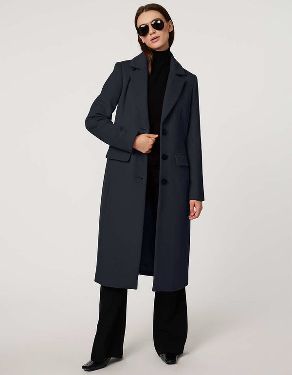 Women’s knee-length wool coat with tailored darts, patch pockets, and single-breasted three-button front.