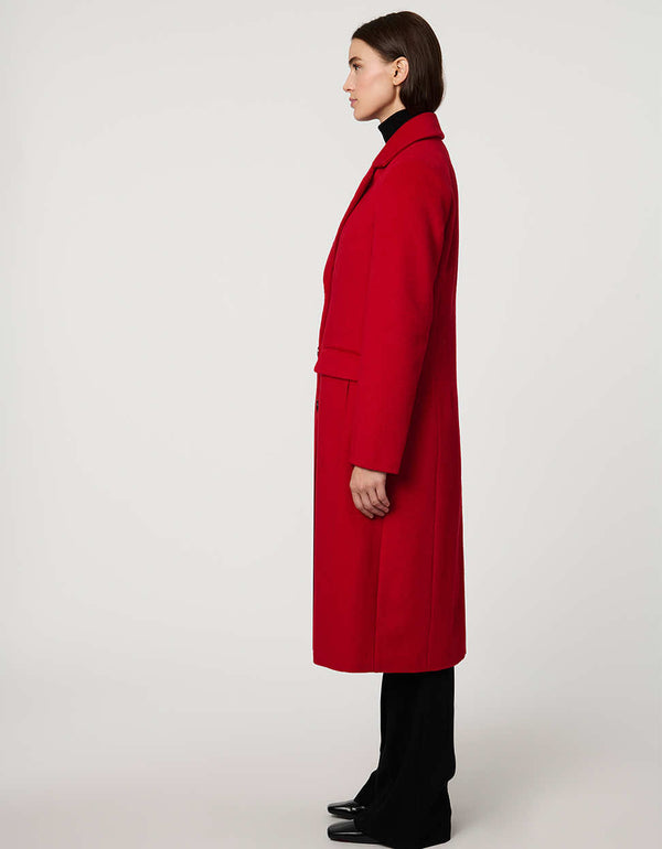 Women’s knee-length wool coat with tailored darts, patch pockets, and single-breasted three-button front.