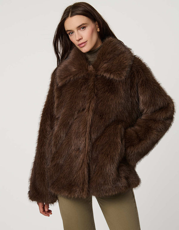 Hip-length faux fur coat with oversized collar, four-button single-breasted front, and welt pockets.